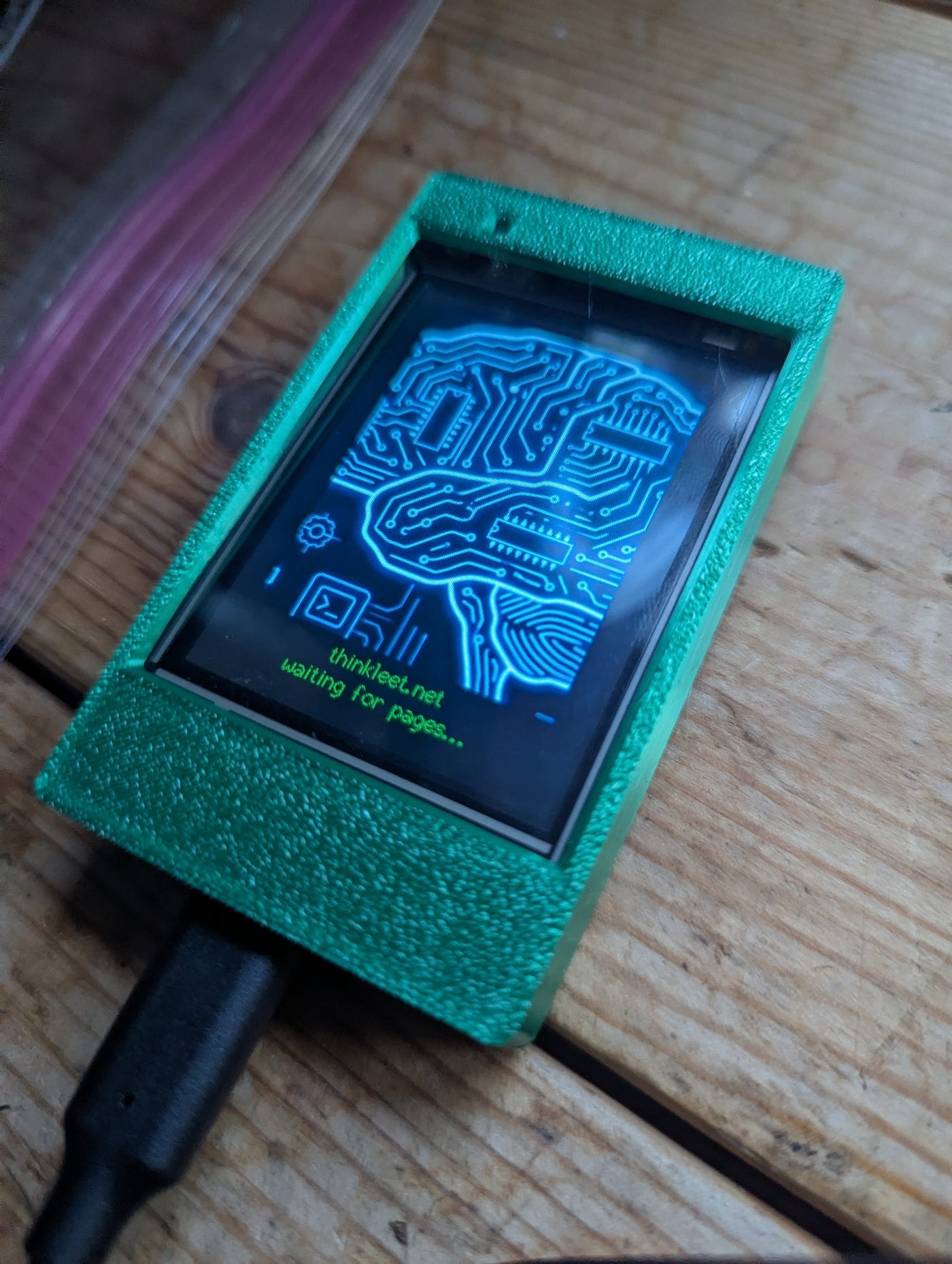 ESP32-2432S024R Cheap Yellow Display running the POCSAG decoder firmware boot logo in a green case