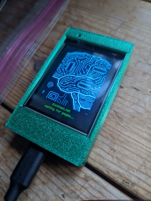 ESP32-2432S024R Cheap Yellow Display running the POCSAG decoder firmware boot logo in a green case